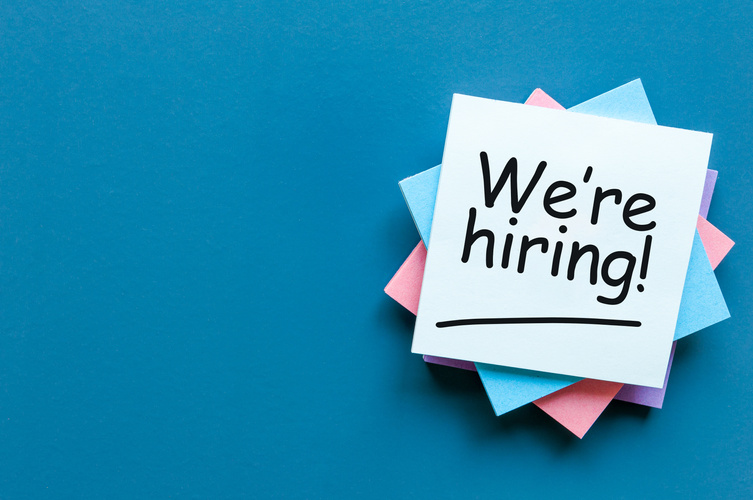WE ARE HIRING CONCEPT ON bright background at new job place. Empty space for text